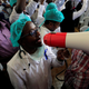 A Kenyan doctor uses a megaphone to shout demands.
